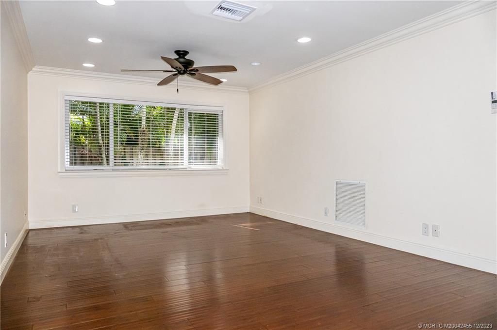 18014 Perigon Way Jupiter, FL 33458 - Photo 28 of 34 an empty room with wooden floor and windows