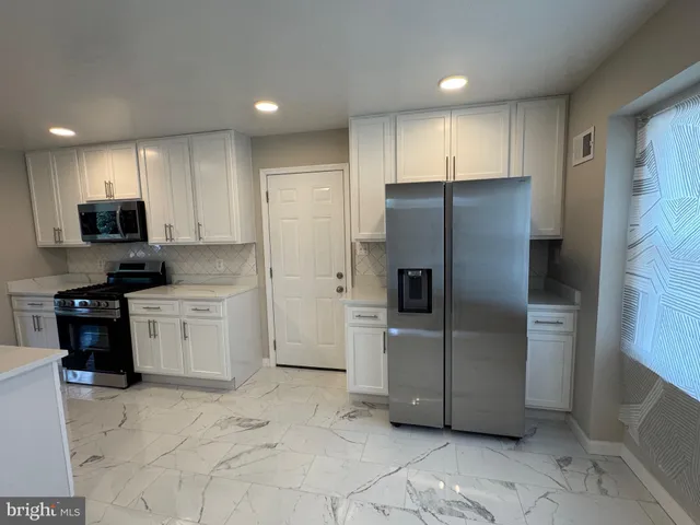 a kitchen with a refrigerator sink and microwave