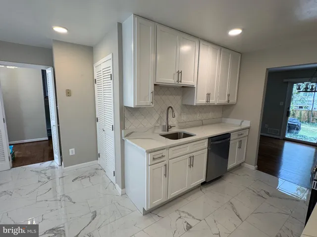 a kitchen with a stove sink and refrigerator
