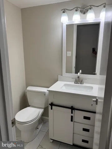 a bathroom with a sink a toilet and mirror
