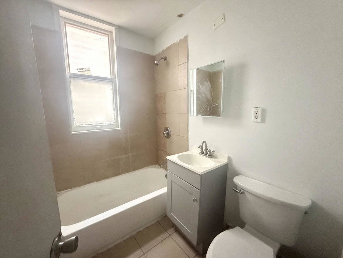 7316 South Perry Avenue Chicago, IL 60621 - Photo 5 of 13 a bathroom with a sink toilet and vanity