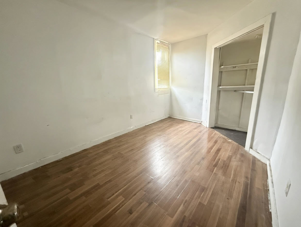 7316 South Perry Avenue Chicago, IL 60621 - Photo 7 of 13 an empty room with wooden floor and closet