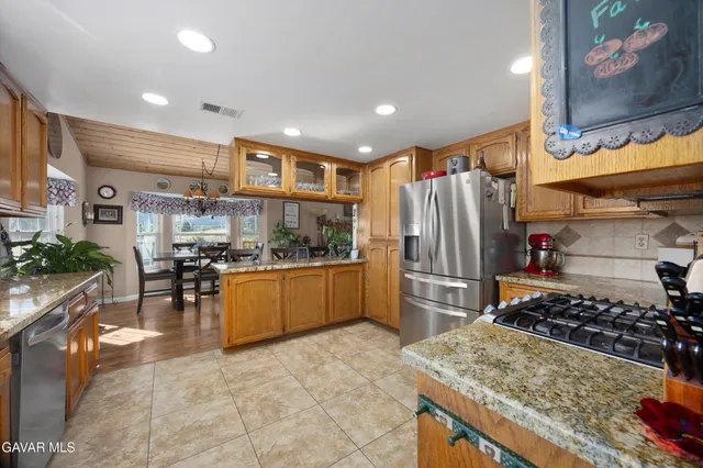 a living room with furniture fireplace and a large window