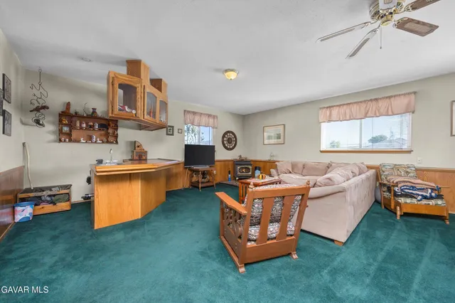 a view of a workspace with furniture and a workspace