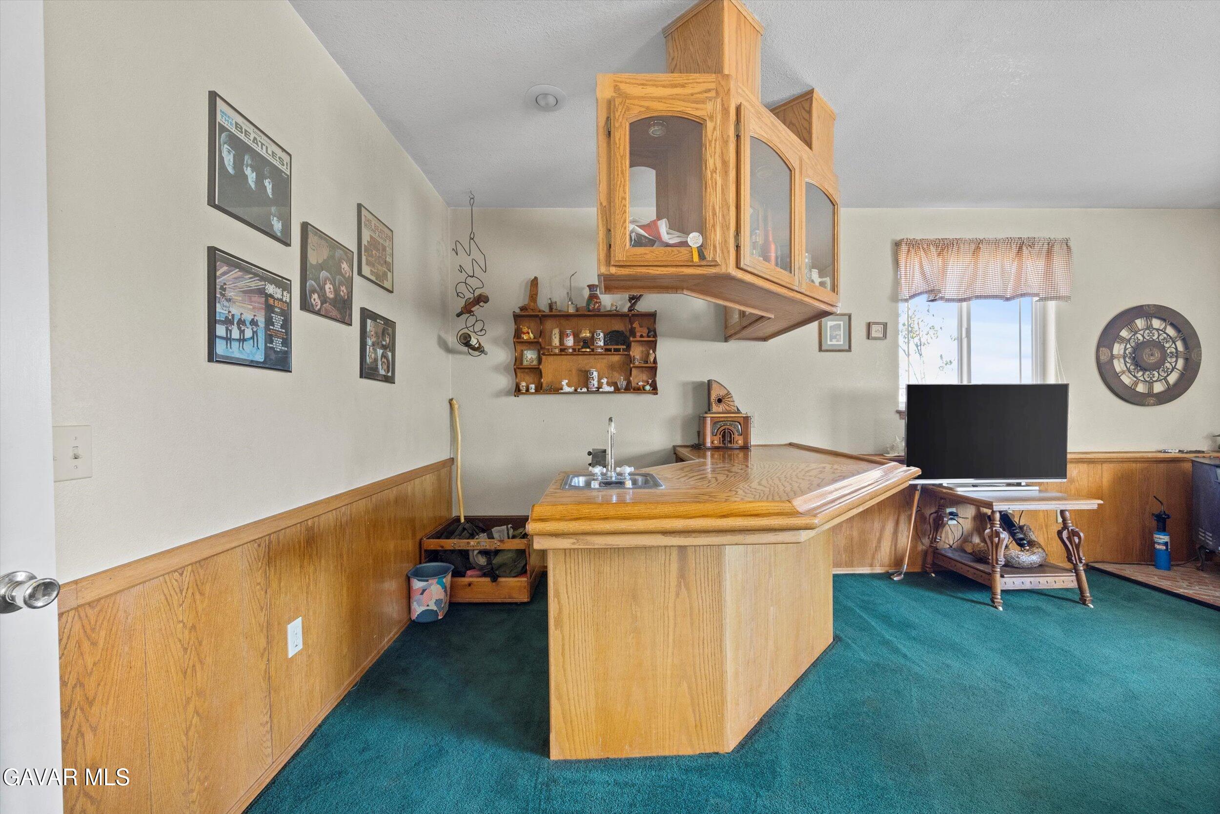 28360 Burning Tree Drive Tehachapi, CA 93561 - Photo 34 of 61 a living room with a table chairs and a kitchen view