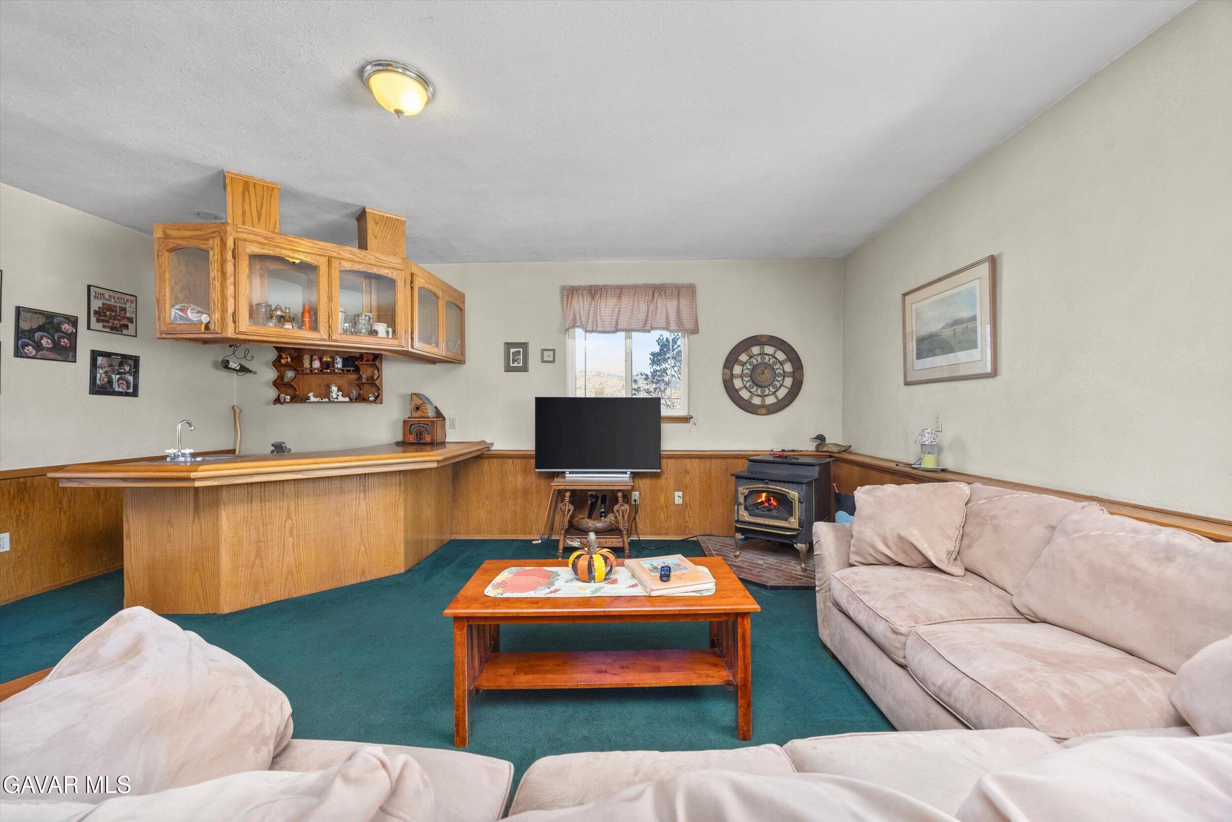 28360 Burning Tree Drive Tehachapi, CA 93561 - Photo 36 of 61 a living room with furniture and a clock