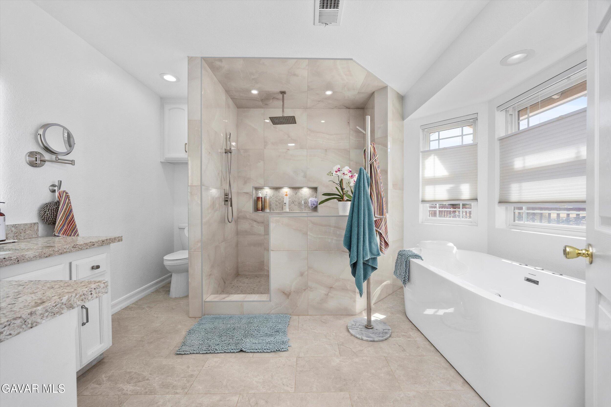 28360 Burning Tree Drive Tehachapi, CA 93561 - Photo 45 of 61 a bathroom with a tub shower and sink