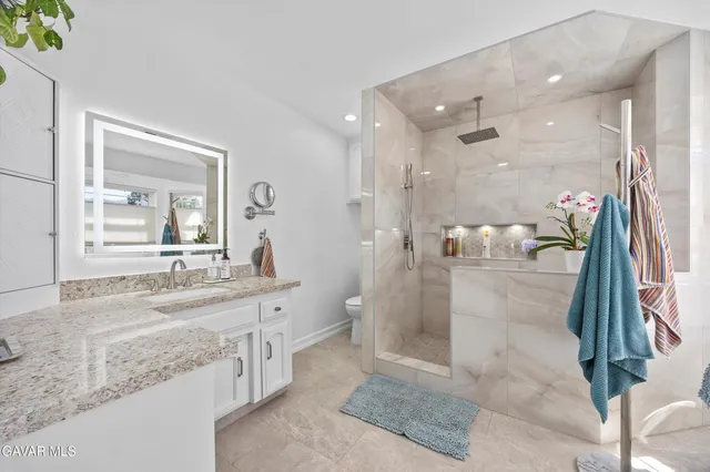 a view of a patio with couches table and chairs and potted plants