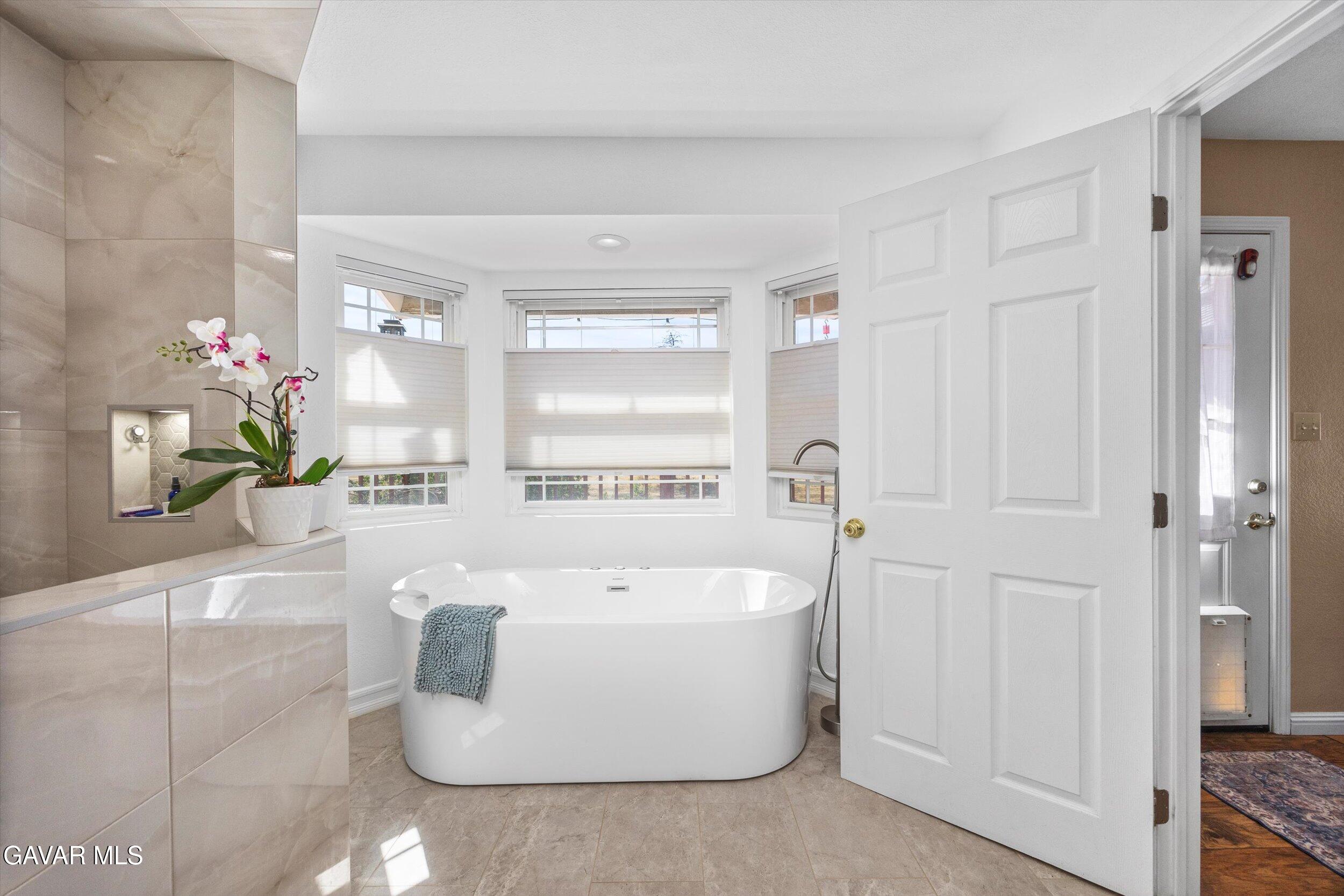 28360 Burning Tree Drive Tehachapi, CA 93561 - Photo 47 of 61 a white bath tub sitting in a bathroom