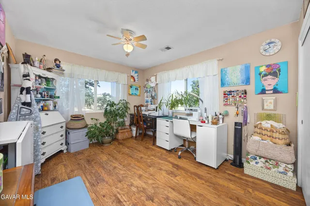 a view of a house with a big yard plants and large trees