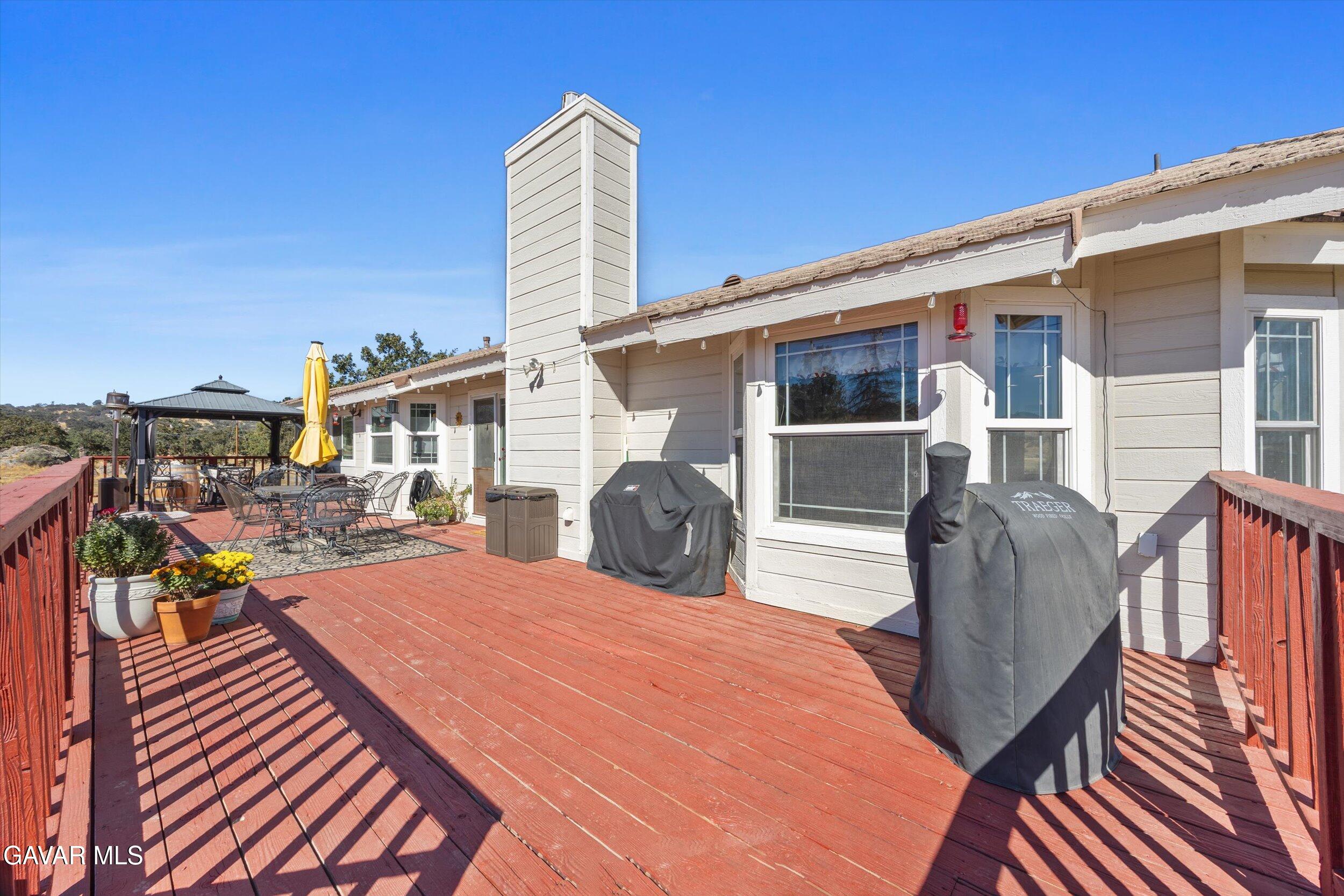 28360 Burning Tree Drive Tehachapi, CA 93561 - Photo 54 of 61 a view of a patio with couches table and chairs and potted plants