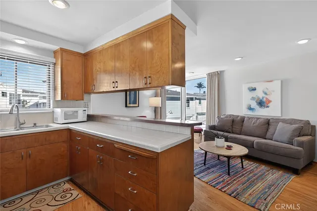 a kitchen with a stove a sink a refrigerator and a cabinets