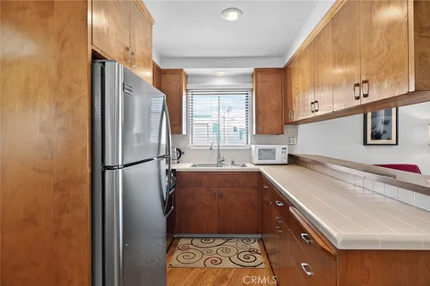 a kitchen with a refrigerator and a sink