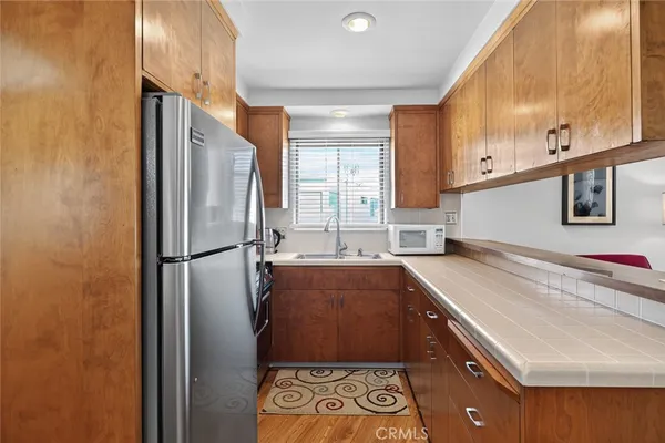 a kitchen with a refrigerator and a sink