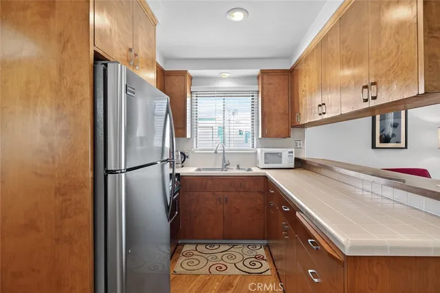 a kitchen with a refrigerator and a sink