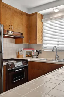 a kitchen with stainless steel appliances a sink stove and cabinets