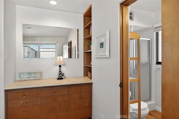 a view of a hallway with couch and a potted plant