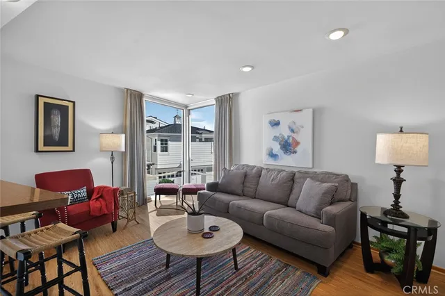 a living room with furniture a rug and a lamp