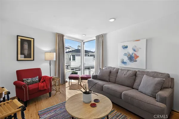 a living room with furniture a rug and a window