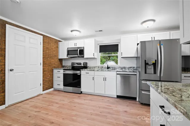a kitchen with a refrigerator stove and microwave