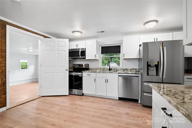 a kitchen with a refrigerator stove and sink