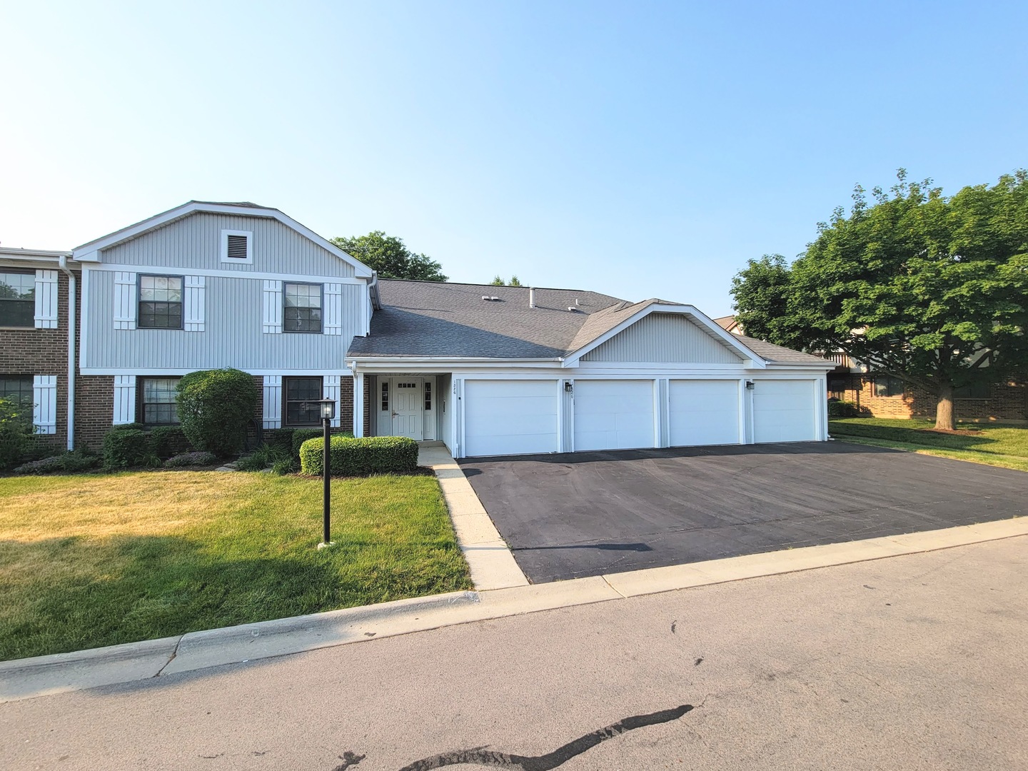 1326 7 Pines Road, Unit D1 Schaumburg, IL 60193 - Photo 1 of 25 a front view of a house with a yard and garage