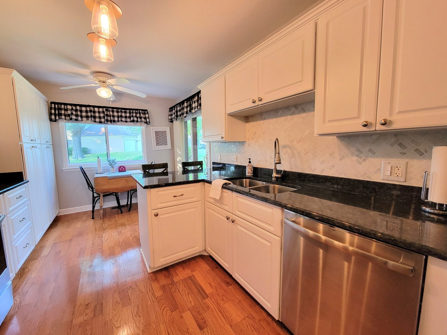 1326 7 Pines Road, Unit D1 Schaumburg, IL 60193 - Photo 9 of 25 a kitchen with stainless steel appliances granite countertop a stove a sink and a microwave