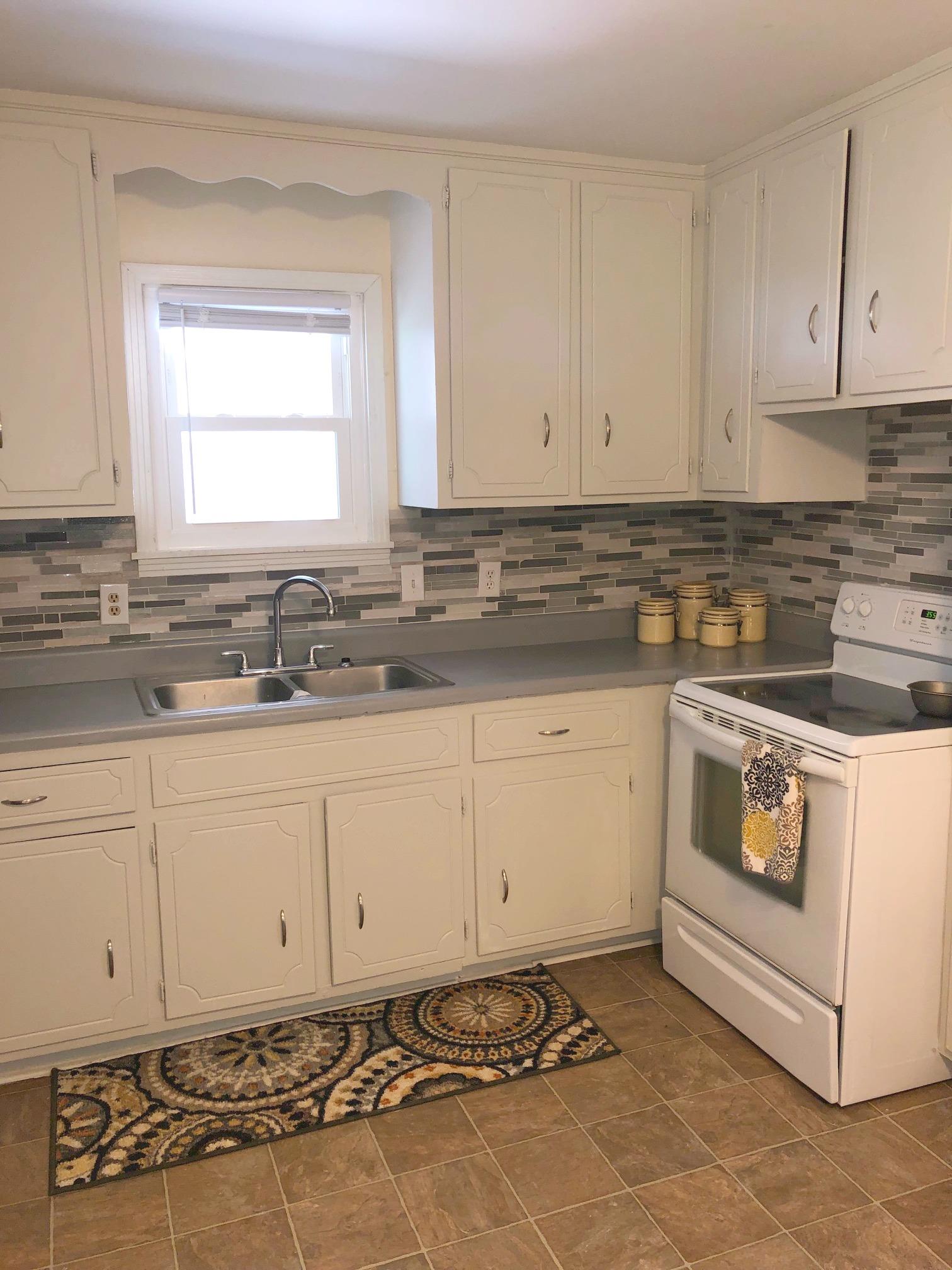 3 Cable Road Oak Grove, KY 42262 - Photo 2 of 17 a kitchen with granite countertop white cabinets sink and dishwasher a stove a refrigerator with white cabinets