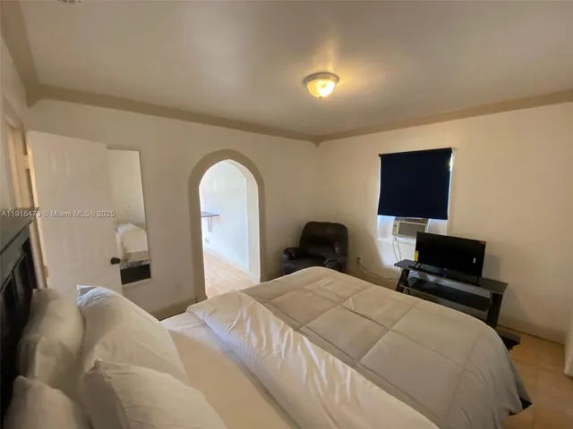 a bedroom with bed and window