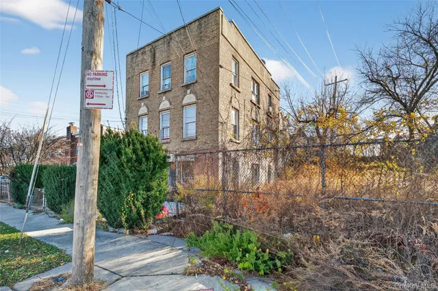 a view of a brick building next to a yard