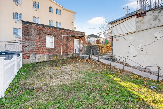 a backyard of a house with yard and outdoor seating