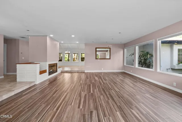 a large white kitchen with a large window