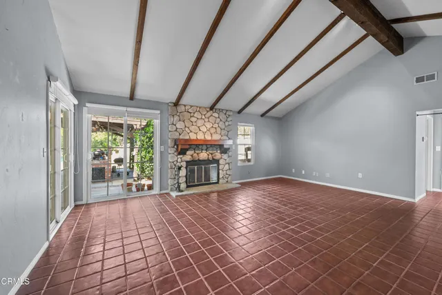 a hallway with a window and a kitchen