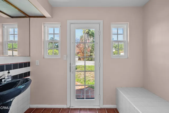 a bathroom with a sink a mirror and a shower