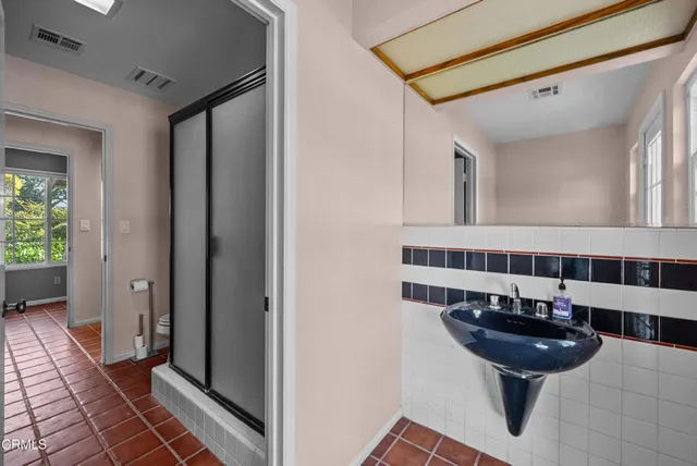 a bathroom with a shower and a toilet