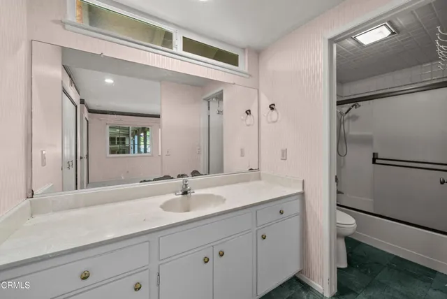 a view of a patio with table and chairs under an umbrella