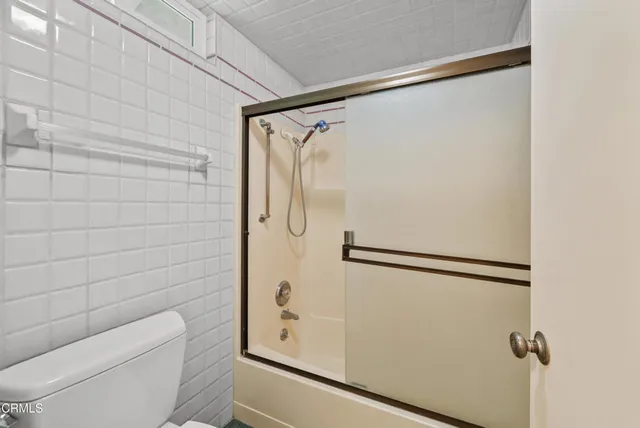 a white house with a yard and a large tree