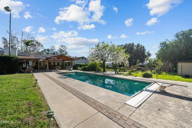 an aerial view of residential houses with yard