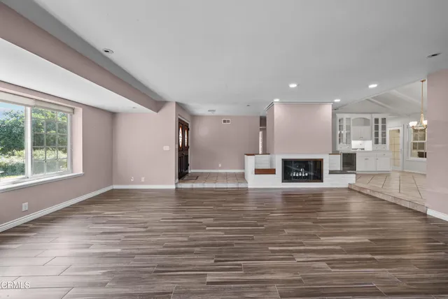 a view of kitchen with windows and chandelier