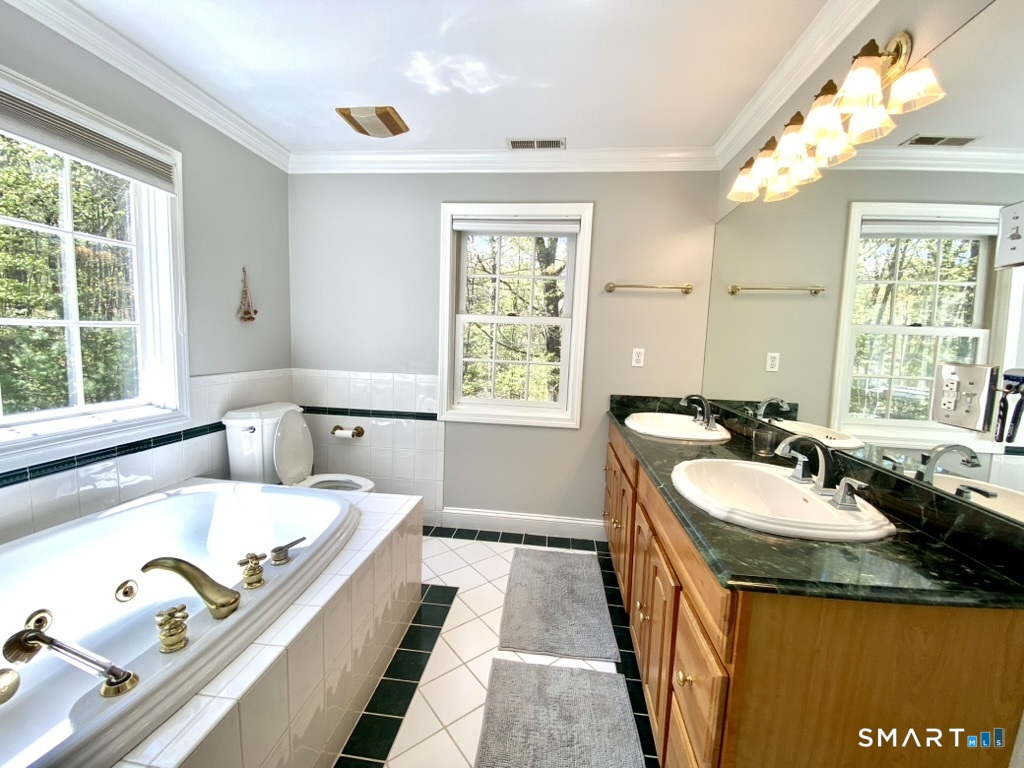 12 Carriage Hill Road Woodbridge, CT 06525 - Photo 15 of 24 a bathroom with a granite countertop sink and a large mirror