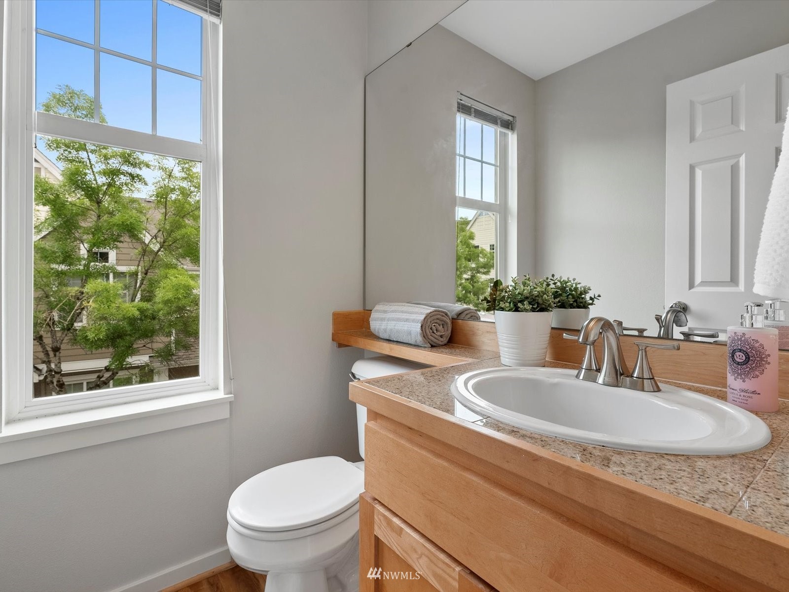 1391 Huckleberry Circle Issaquah, WA 98029 - Photo 13 of 32 a bathroom with a granite countertop sink a toilet and a window