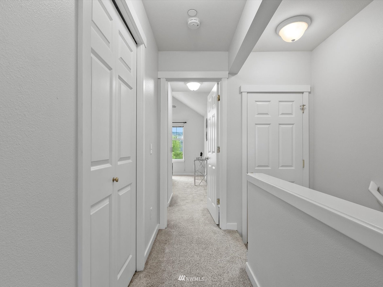 1391 Huckleberry Circle Issaquah, WA 98029 - Photo 14 of 32 a view of a hallway with closet and wooden floor