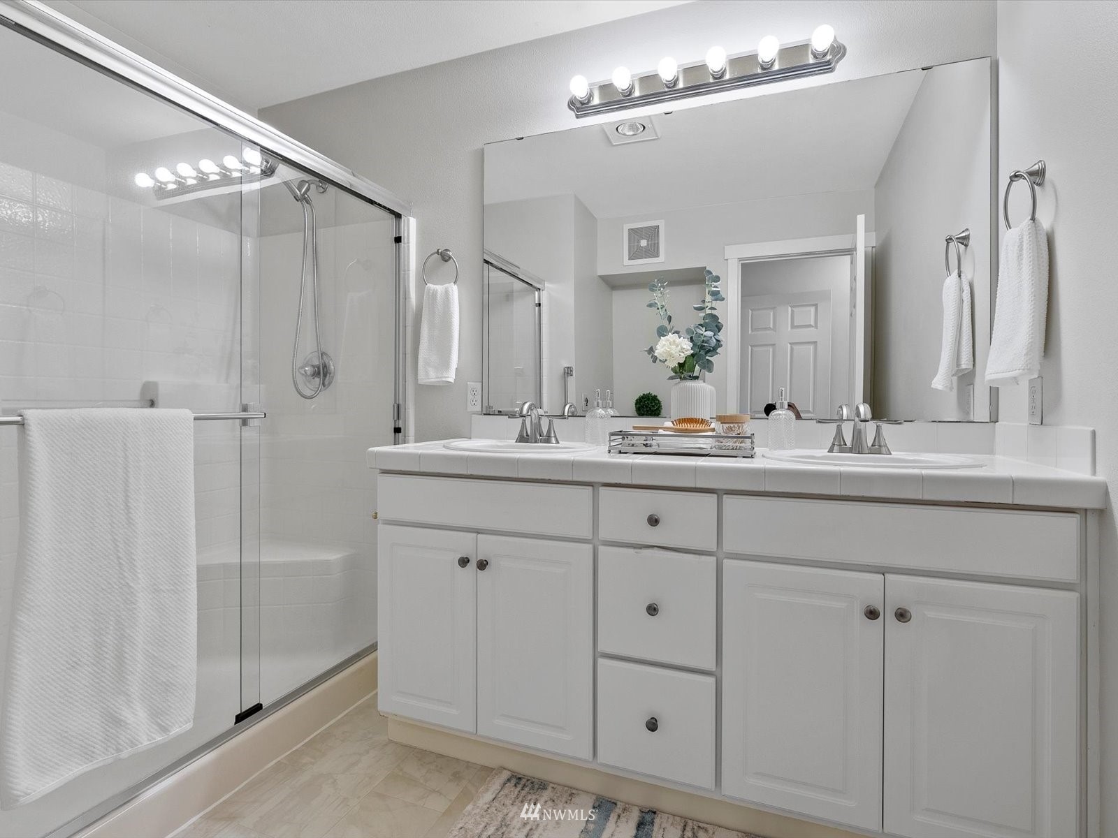 1391 Huckleberry Circle Issaquah, WA 98029 - Photo 15 of 32 a bathroom with double vanity sink and a mirror