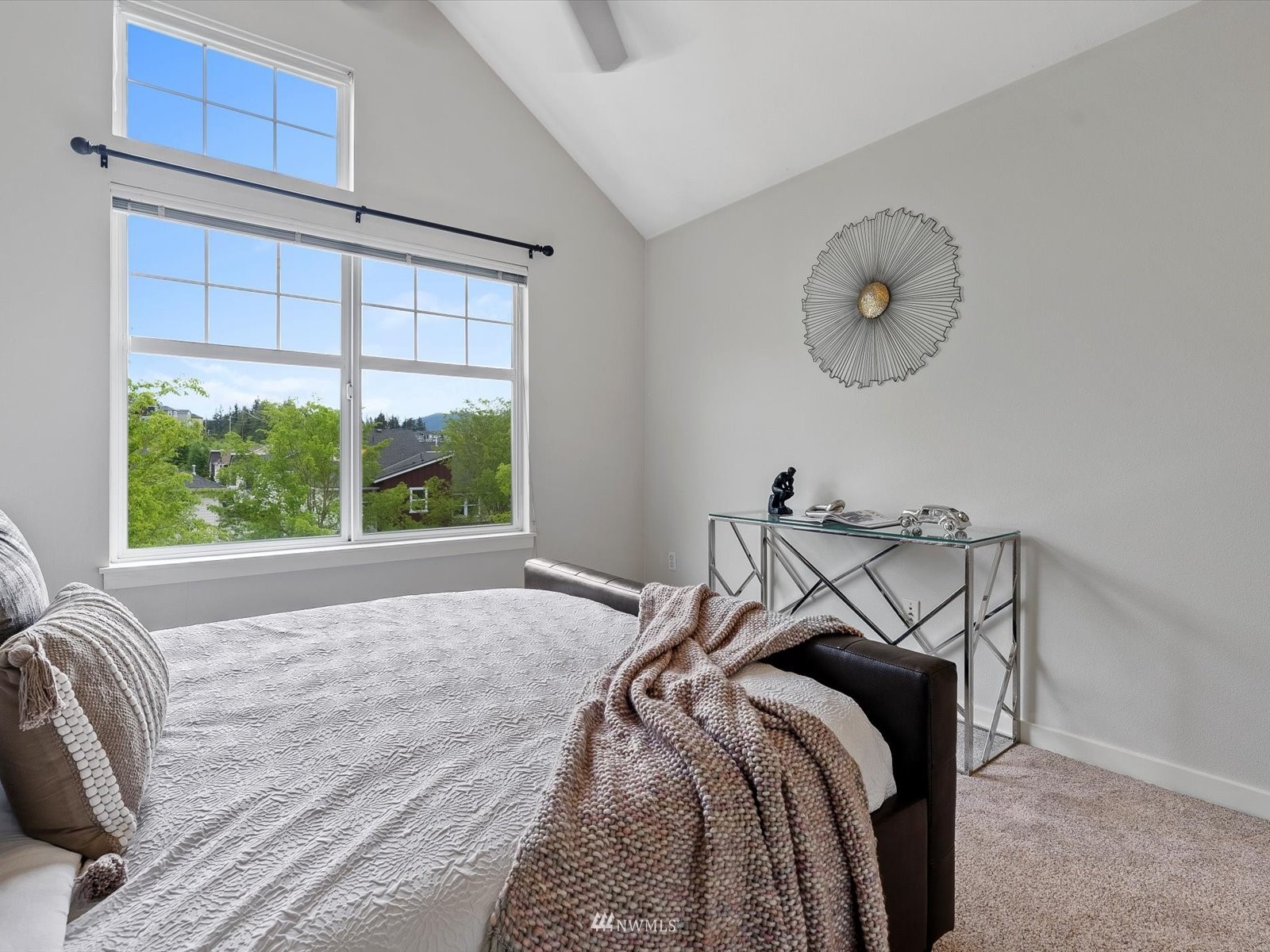 1391 Huckleberry Circle Issaquah, WA 98029 - Photo 17 of 32 a bed sitting in a bedroom next to a window