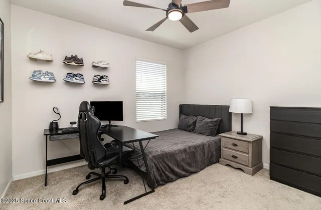 a bedroom with a bed and a desk