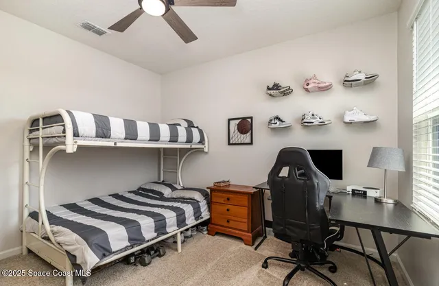 a bedroom with a bed and a desk