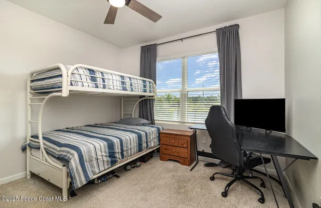 a bedroom with a bed chair and a window