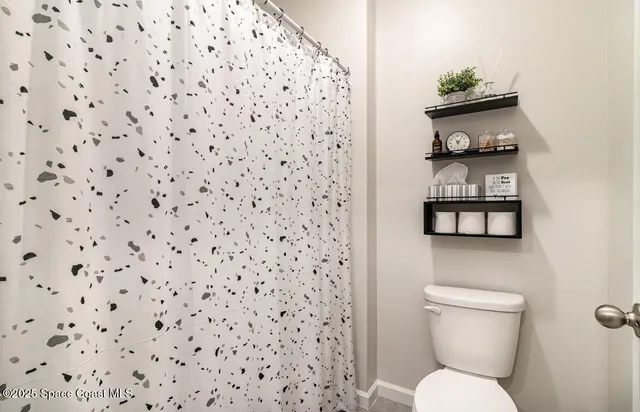 a white toilet sitting next to a bathroom sink