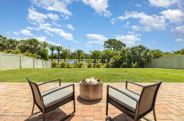 a view of a two chairs and a table in a yard