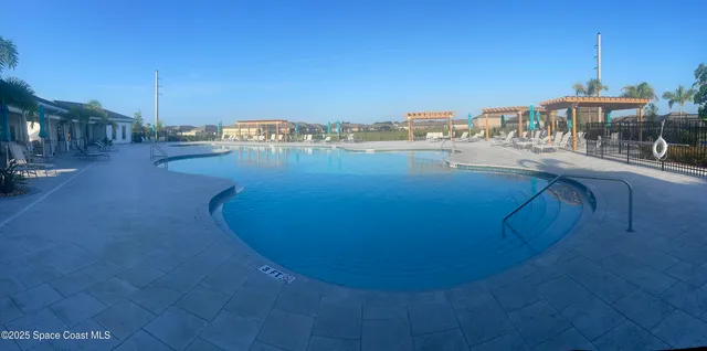 a view of a swimming pool with a yard